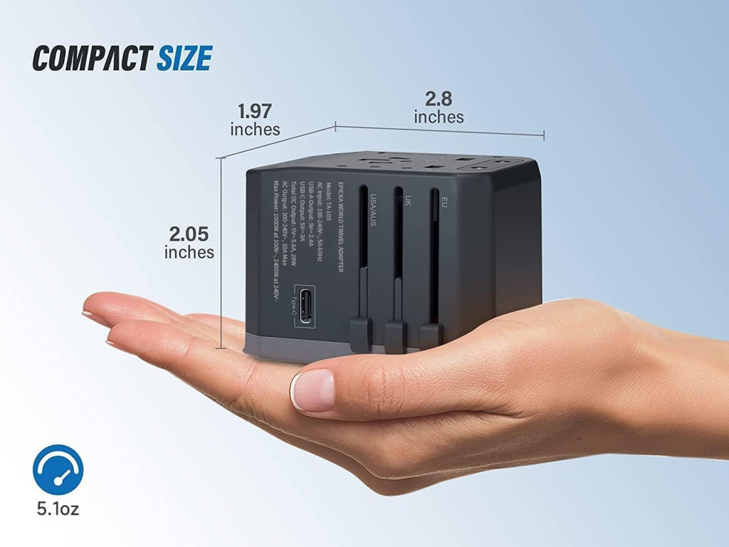 Compact 5.1oz universal world travel adapter (2.8 x 2.05 x 1.97 inches) held in hand, displaying multi-region plugs.