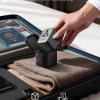 Compact Epicka 65W universal travel adapter with carrying bag in a suitcase