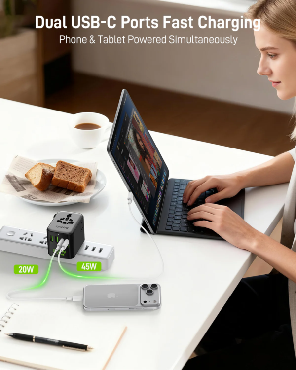 Dual USB-C fast charging travel adapter powering phone and laptop simultaneously.