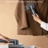 versatile-dual-voltage-global-travel-garment-steamer 2-in-1 handheld garment steamer and iron, used for vertical steaming a blazer and horizontal ironing.